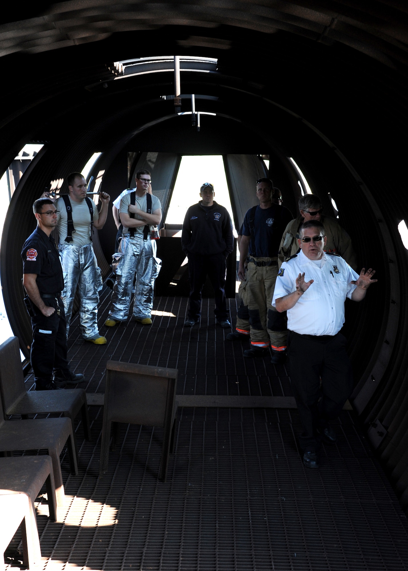 David Anderson, 319th Civil Engineer Squadron assistant fire chief of operations, briefs members of the Grand Forks Fire Department before a training exercise Sept. 1, 2015, on Grand Forks Air Force Base, North Dakota. The GFFD joined the Grand Forks AFB Fire Department to learn techniques for fighting aircraft fires. The live fire training aircraft allowed a realistic training experience. (U.S. Air Force photo by Airman 1st Class Ryan Sparks/Released)