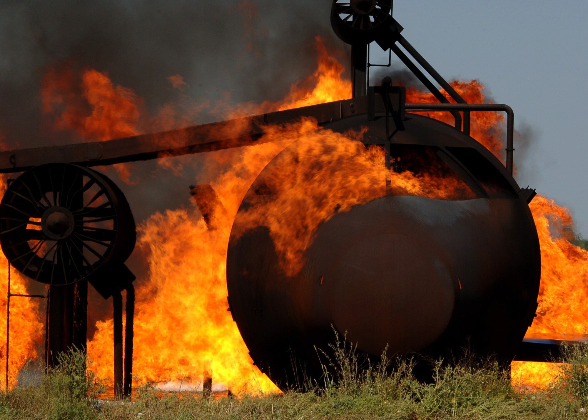 Fire engulfs a training aircraft during a joint training exercise Sept. 2, 2015, on Grand Forks Air Force Base, North Dakota. Members of the Grand Forks Fire Department came to Grand Forks AFB to utilize the Grand Forks AFB Fire Department?s training resources. The GFFD and Grand Forks AFB Fire Department work together for training purposes when possible to conserve resources. (U.S. Air Force photo by Airman 1st Class Ryan Sparks/Released)
