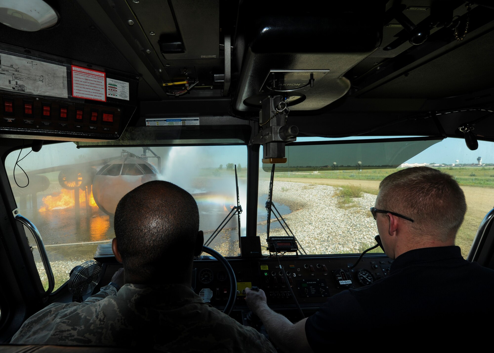 A member of the Grand Forks Fire Department controls the hose during a live fire exercise Sept. 2, 2015, on Grand Forks Air Force Base, North Dakota. The GFFD joined the Grand Forks AFB Fire Department to learn the proper techniques and tactics used to fight an aircraft fire. (U.S. Air Force photo by Airman 1st Class Ryan Sparks/Released)