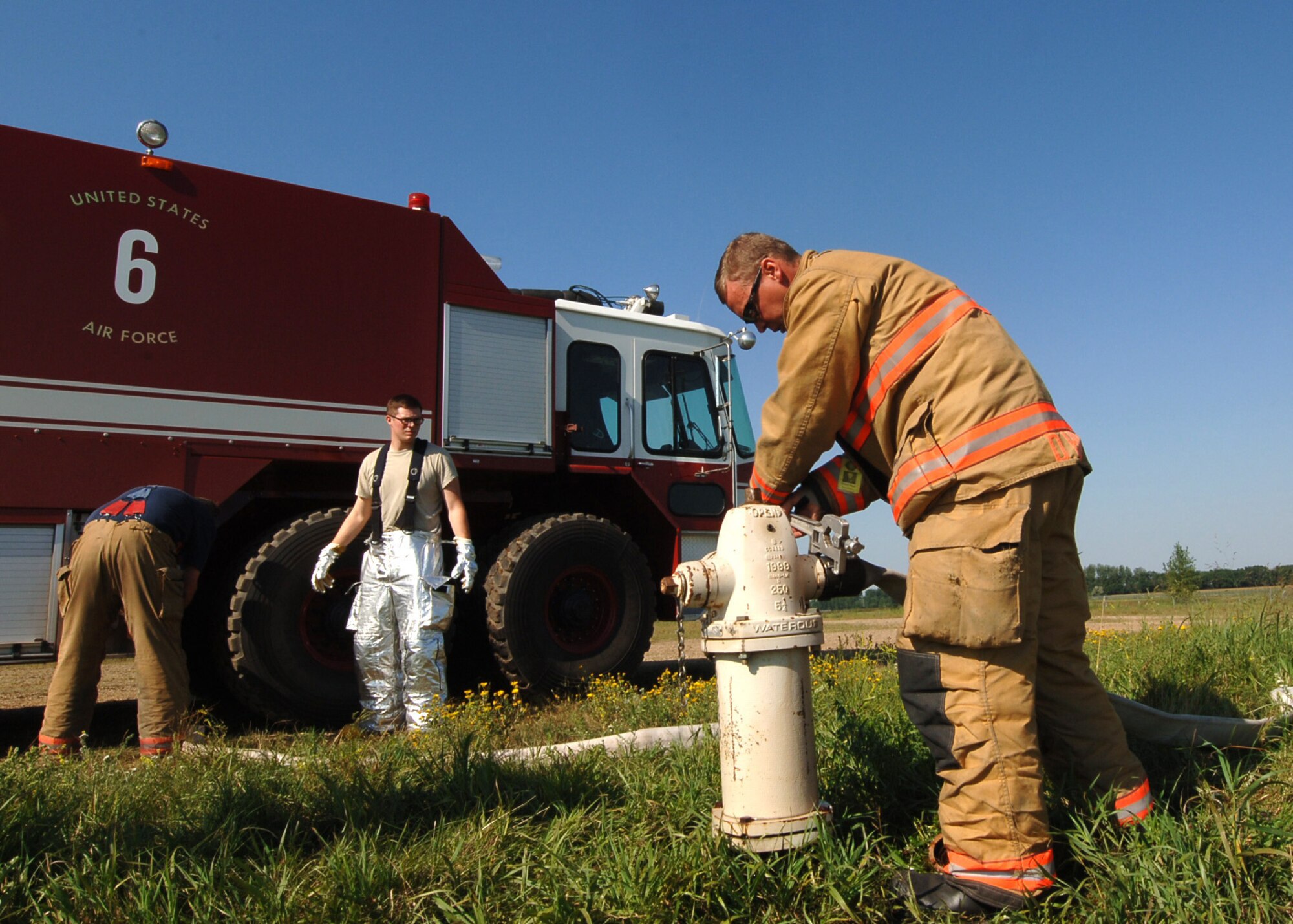 DelRay Huot, Grand Forks Fire Department fire apparatus specialist, connects a hose to the fire hydrant Sept. 1, 2015, on Grand Forks Air Force Base, North Dakota. Huot and other members of the GFFD participated in a joint training exercise focusing on aircraft fires. (U.S. Air Force photo by Airman 1st Class Ryan Sparks/Released)