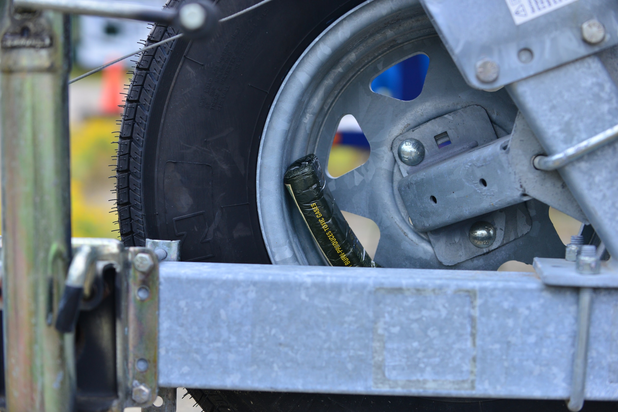A mock explosive rests in a tire rim during a week-long explosive detection certification course at Fort Eustis, Va., Aug. 31, 2015.  Canines and handlers participated in several detection courses throughout the week to gain certification for military operations. (U.S. Air Force photo by Staff Sgt. Natasha Stannard/Released)