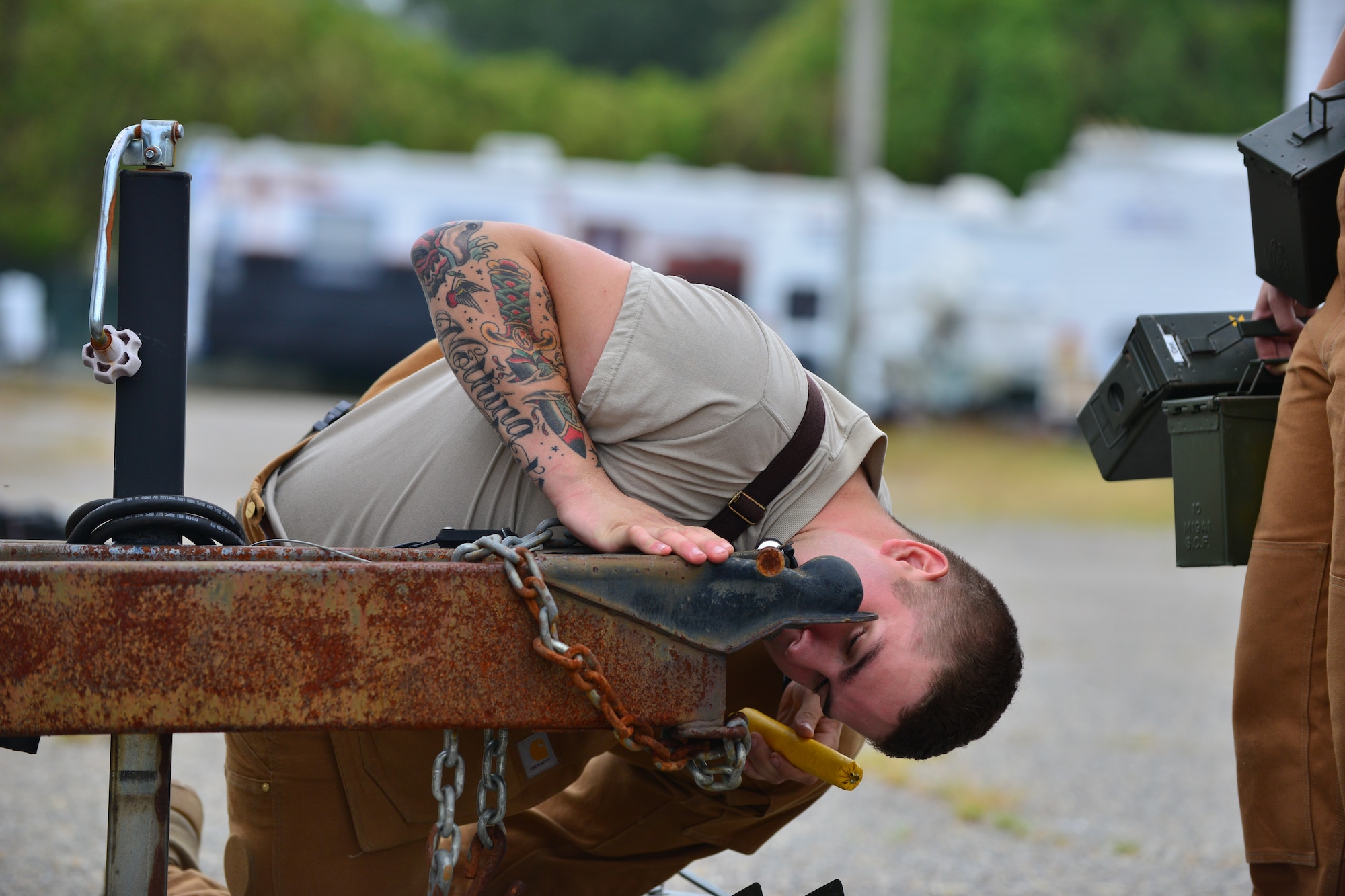 U.S. Army Spc. Brandon Ward, 3rd Military Police Detachment explosives canine handler, hides a mock explosive during a week-long explosive detection certification course at Fort Eustis, Va., Aug. 31, 2015. The course aimed to ensure contracted explosives detection canines and handlers met military standards.  (U.S. Air Force photo by Staff Sgt. Natasha Stannard/Released)
