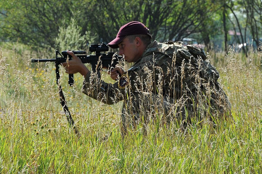 Members of the 91st Security Forces Group Global Strike Challenge team crouch down during tactical training at Minot Air Force Base, N.D., Sept. 2, 2015. To train for the GSC, the team has been doing physical and mental training every day, as well as working on their tactics and teamwork. (U.S. Air Force photo / Senior Airman Kristoffer Kaubisch)