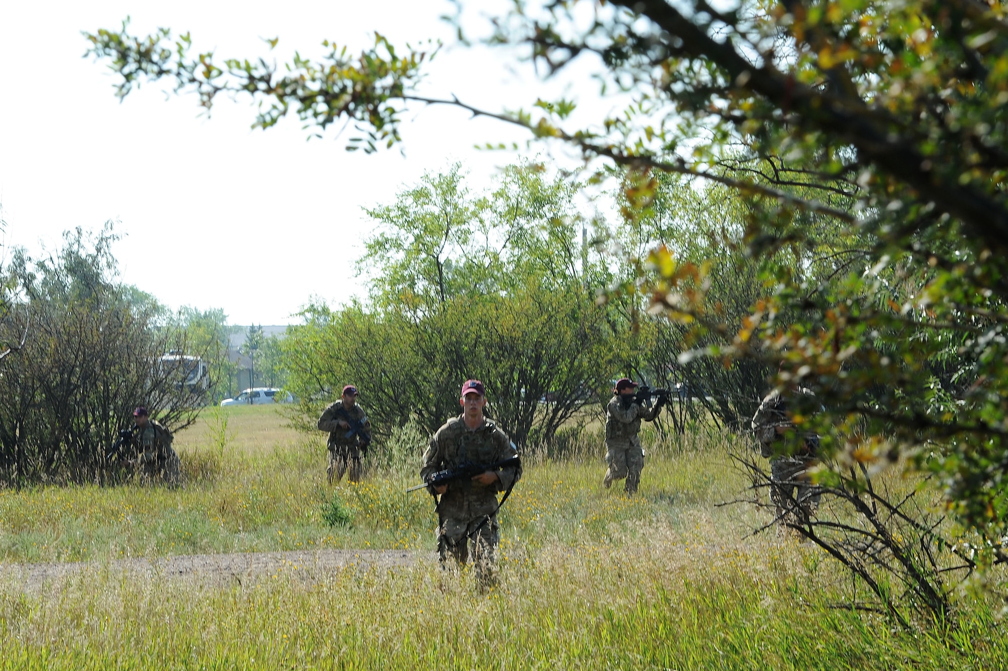 Senior Airman Brandon Weese, 91st Security Forces Group Global Strike Challenge team, crouches down during tactical training at Minot Air Force Base, N.D., Sept. 2, 2015. To train for the GSC, the team has been doing physical and mental training every day, as well as working on their tactics and teamwork. (U.S. Air Force photo / Senior Airman Kristoffer Kaubisch)