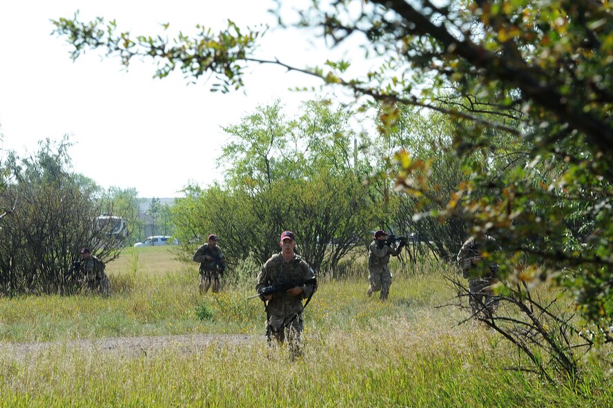 Senior Airman Brandon Weese, 91st Security Forces Group Global Strike Challenge team, crouches down during tactical training at Minot Air Force Base, N.D., Sept. 2, 2015. To train for the GSC, the team has been doing physical and mental training every day, as well as working on their tactics and teamwork. (U.S. Air Force photo / Senior Airman Kristoffer Kaubisch)