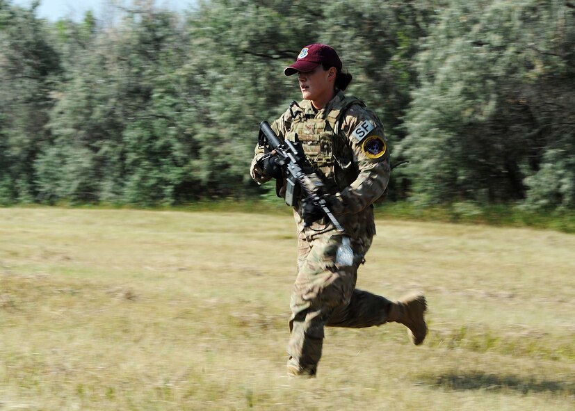 Staff Sgt. Christina Lee, 91st Security Forces Group Global Strike Challenge team, runs through a field during tactical training at Minot Air Force Base, N.D., Sept. 2, 2015. To train for the GSC, the team has been doing physical and mental training every day, as well as working on their tactics and teamwork. (U.S. Air Force photo / Senior Airman Kristoffer Kaubisch)