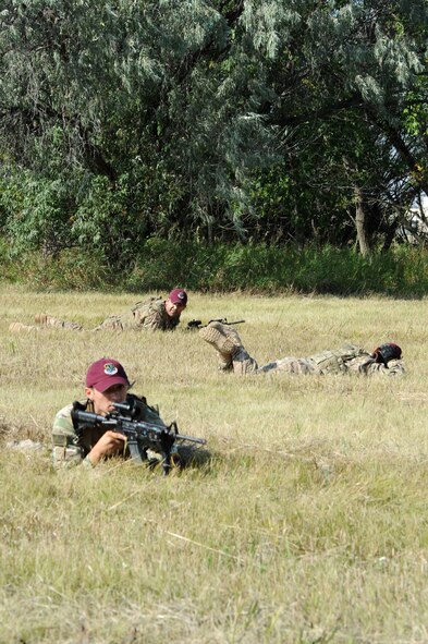 Members of the 91st Security Forces Group Global Strike Challenge team lay in cover during tactical training at Minot Air Force Base, N.D., Sept. 2, 2015. To train for the GSC, the team has been doing physical and mental training every day, as well as working on their tactics and teamwork. (U.S. Air Force photo / Senior Airman Kristoffer Kaubisch)