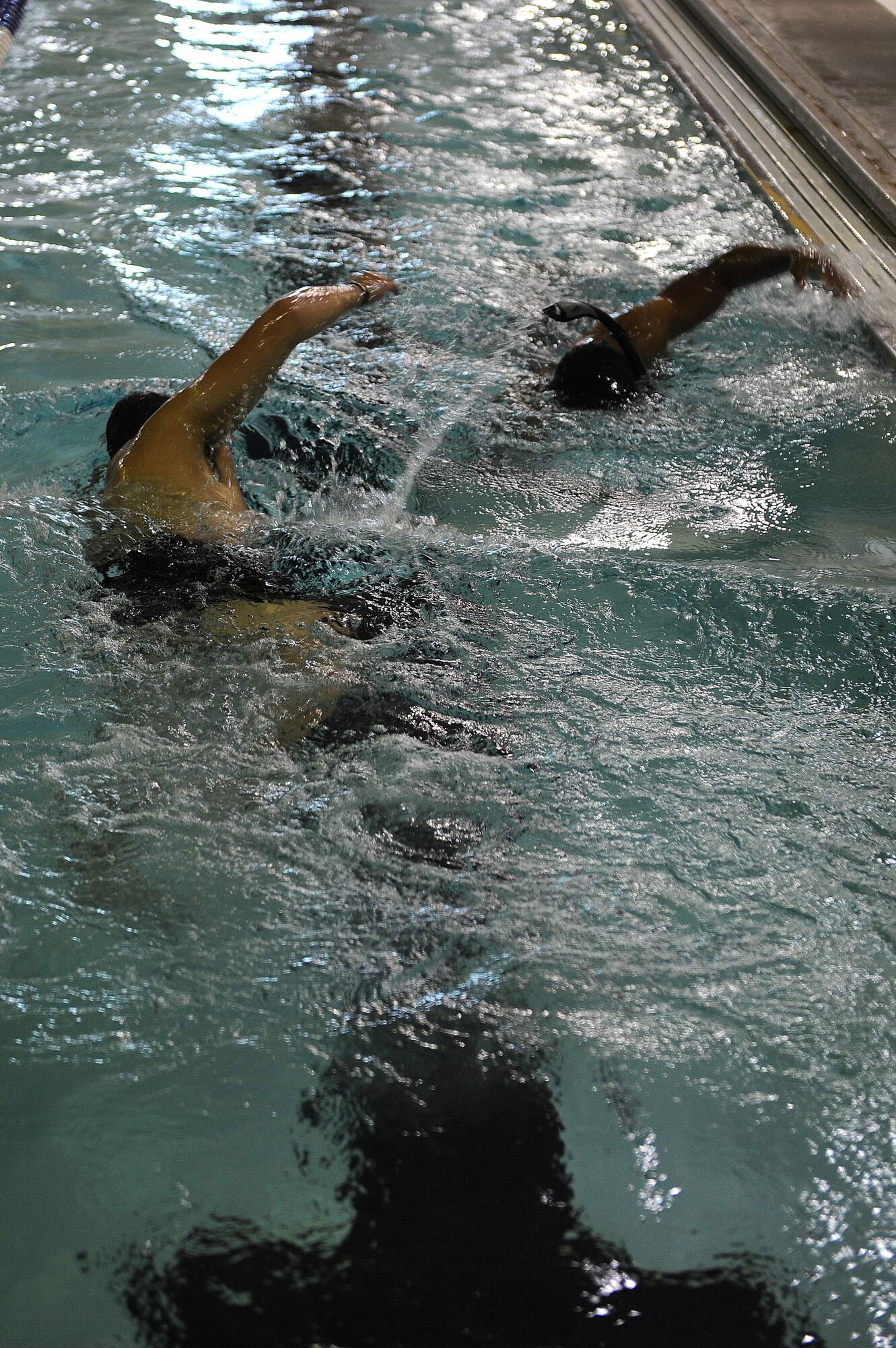 Members from the 91st Security Forces Group Global Strike Challenge team swim laps at Minot Air Force Base, N.D., Sept. 1, 2015. To train for the GSC, the team has been doing physical and mental training every day, as well as working on their tactics and teamwork. (U.S. Air Force photo / Senior Airman Kristoffer Kaubisch)