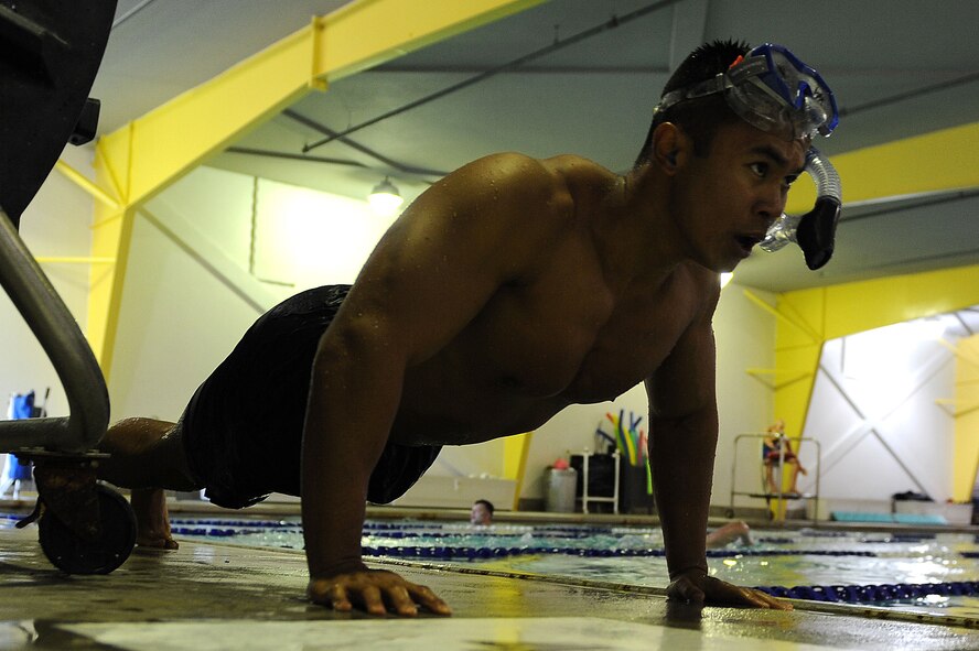 1st Lt. Kschristopher Anda, 91st Security Forces Group Global Strike Challenge team, does push-ups after swimming laps at Minot Air Force Base, N.D., Sept. 1, 2015. Anda is one of the team captains for the 91st SFG GSC team and is pushing his team mentally and physically every day to train for the upcoming competition.  (U.S. Air Force photo / Senior Airman Kristoffer Kaubisch)   