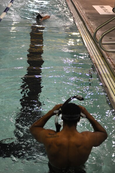 Airman 1st Class Andreas Wiggins, 91st Security Forces Group Global Strike Challenge team, prepares to swim a lap at Minot Air Force Base, N.D., Sept. 1, 2015. To train for the GSC, the team has been doing physical and mental training every day, as well as working on their tactics and teamwork. (U.S. Air Force photo / Senior Airman Kristoffer Kaubisch)