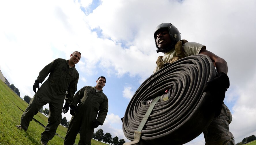 U.S. Air Force Airman 1st Class Joshua Sledge, 100th Logistics Readiness Squadron mobile distribution operator, lifts 100 feet of hose during tryouts for the Forward Area Refueling Point team Sept. 3, 2015, on RAF Mildenhall, England. RAF Mildenhall is one of five bases across the Air Force with a FARP team. Members are selected after a vigorous tryout and interview session to test an Airman’s skill and dedication. Utilized mostly in potentially hazardous areas, a FARP is the process of refueling aircraft on the ground from another parked aircraft. (U.S. Air Force photo by Senior Airman Kate Thornton/Released)