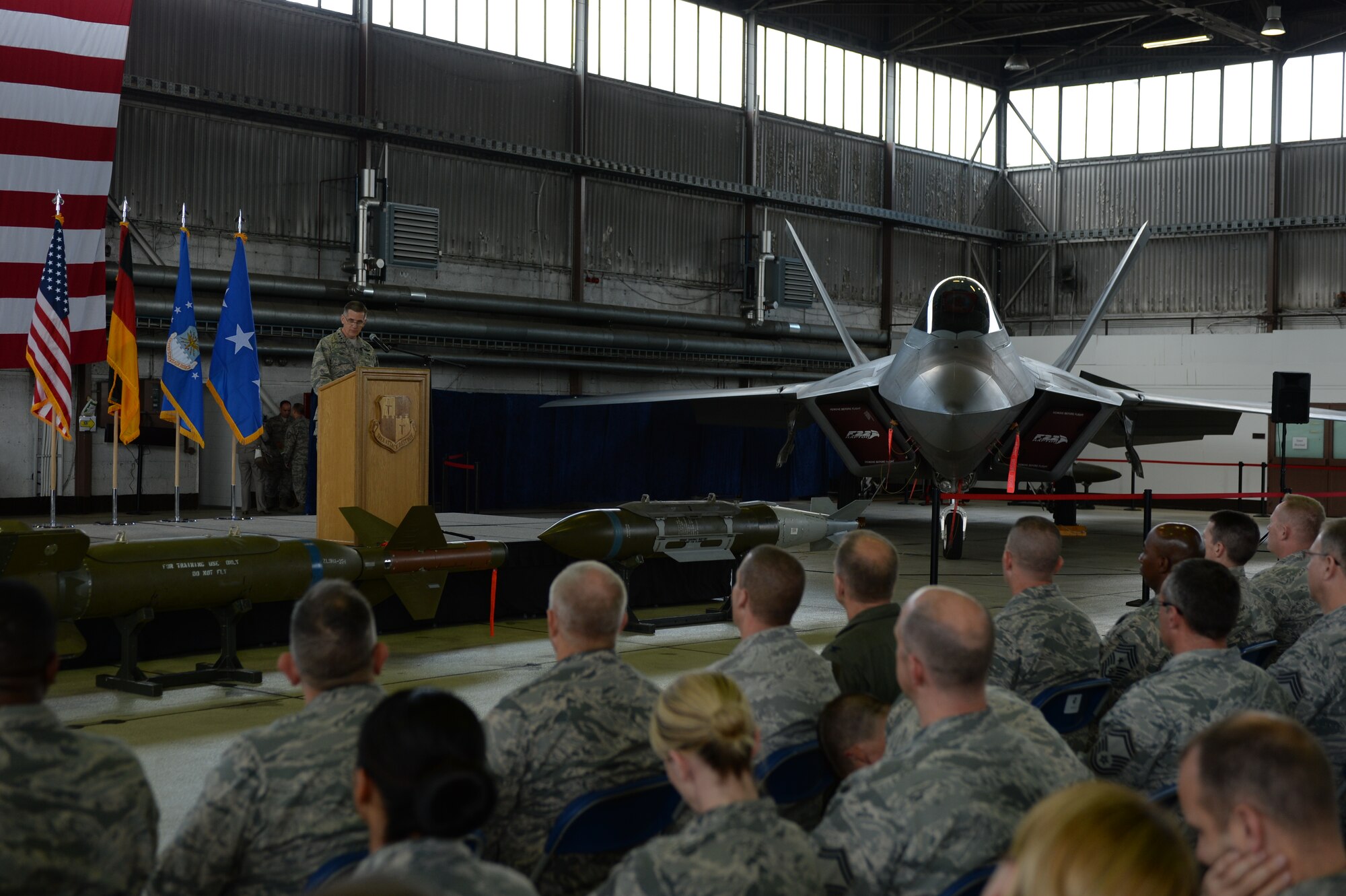 U.S. Air Force Lt. Gen. Timothy Ray, 3rd Air Force and 17th Expeditionary Air Force commander speaks to Airmen and journalists during a media event in front of a U.S. Air Force F-22 Raptor at Hangar One at Spangdahlem Air Base, Germany, Sept. 3, 2015. The aircraft will conduct air training with other Europe-based aircraft and will also forward deploy from Germany to maximize training opportunities while demonstrating the U.S. commitment to NATO allies and the security of Europe. The F-22s are deployed from the 95th Fighter Squadron at Tyndall Air Force Base, Florida. (U.S. Air Force photo by Staff Sgt. Joe W. McFadden/Released)
