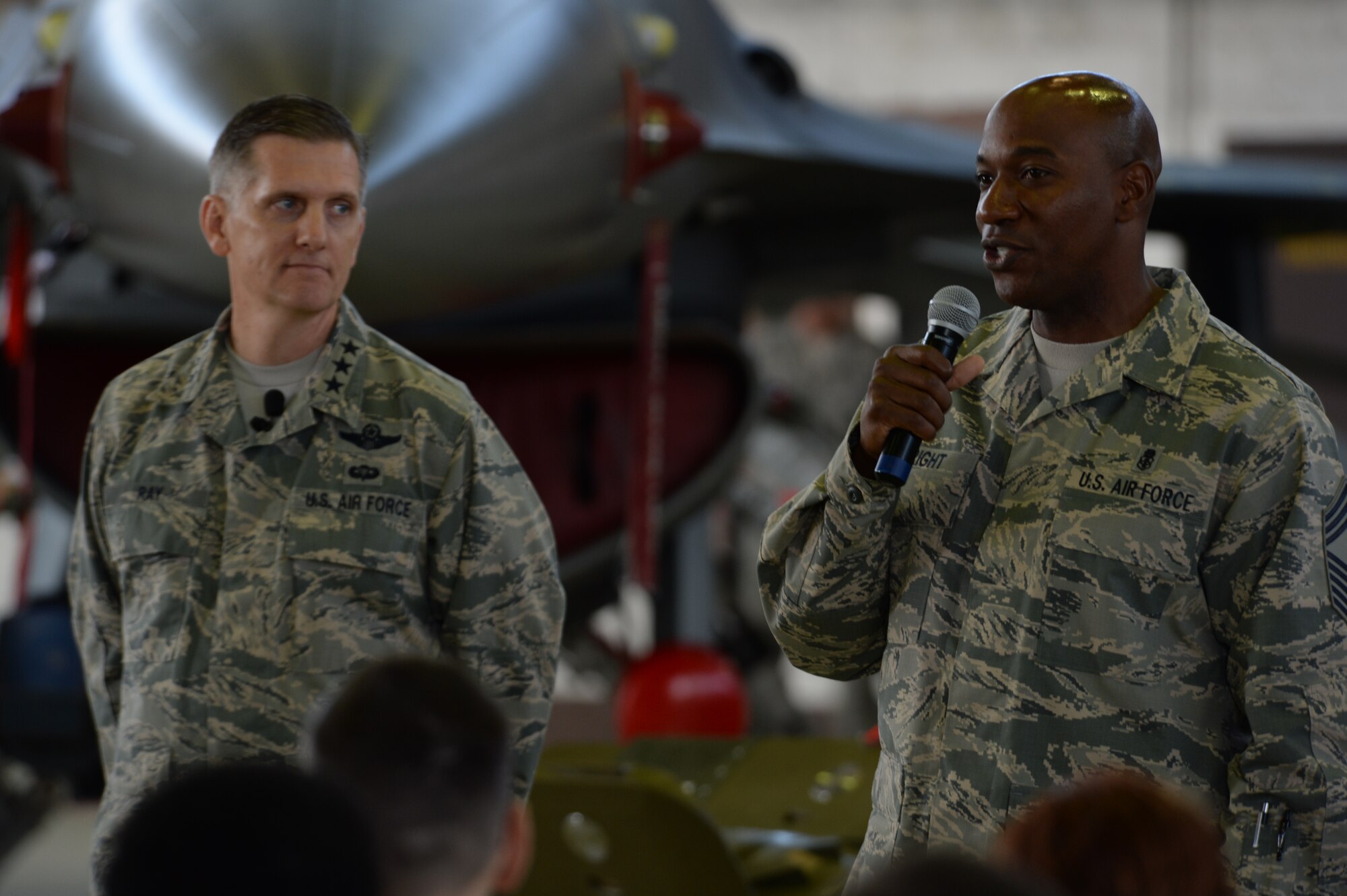 U.S. Air Force Lt. Gen. Timothy Ray, 3rd Air Force and 17th Expeditionary Air Force commander, left, and U.S. Air Force Chief Master Sgt. Kaleth Wright, 3rdAF and 17thEAF command chief, right, speak to Airmen during an all-call at Hangar One at Spangdahlem Air Base, Germany, Sept. 3, 2015. Third AF is U.S. Air Forces in Europe’s and 17th EAF is Air Forces Africa’s numbered air force for U.S. European Command and U.S. Africa Command. Third AF and 17th EAF plans, deploys, sustains and redeploys Air Force forces that directly support the combatant commanders during contingency and wartime operations.  (U.S. Air Force photo by Staff Sgt. Joe W. McFadden/Released)