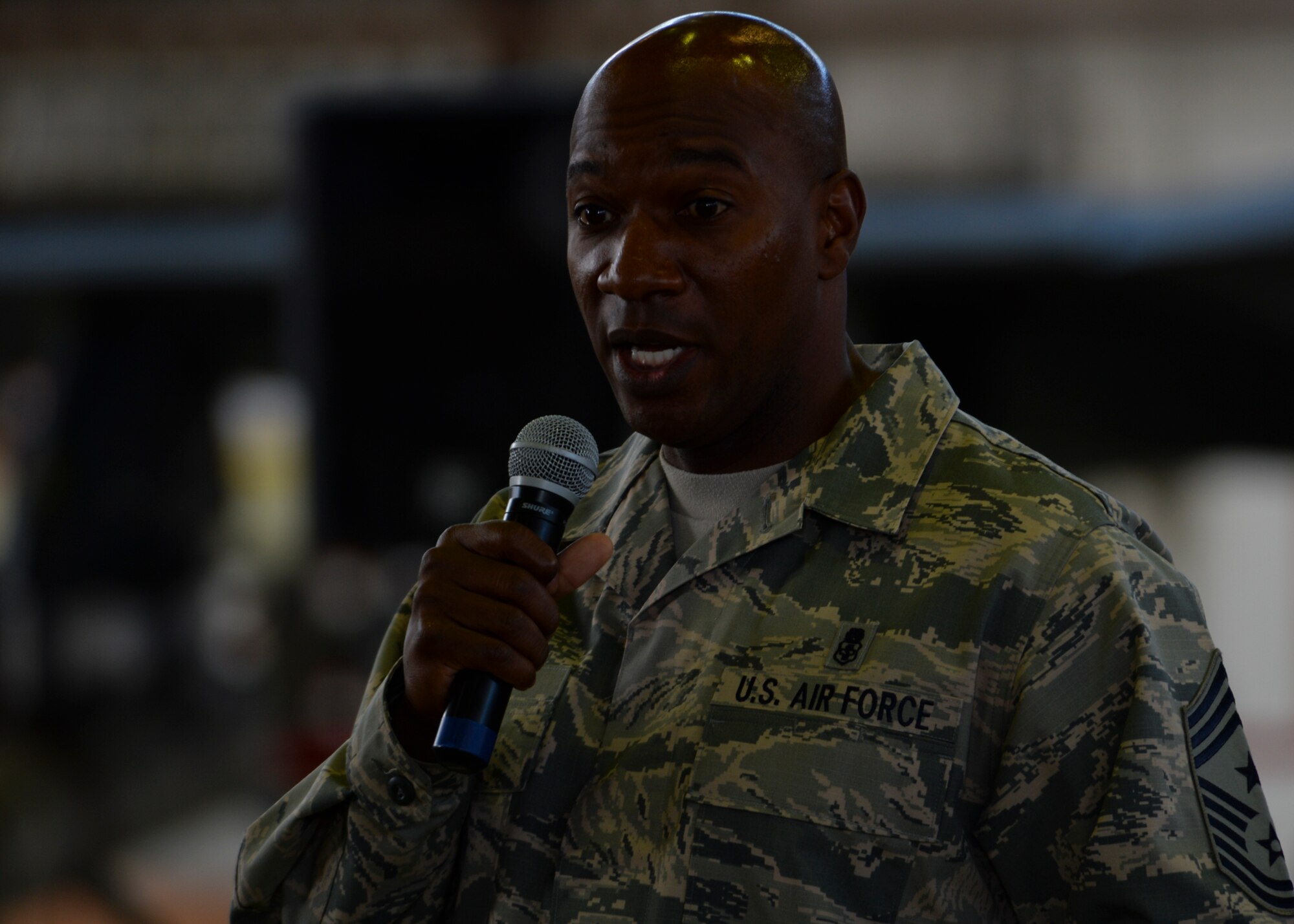 U.S. Air Force Chief Master Sgt. Kaleth Wright, 3rd Air Force and 17th Expeditionary Air Force command chief, speaks to Airmen during an all-call at Hangar One at Spangdahlem Air Base, Germany, Sept. 3, 2015. Wright has served as the 3rd AF and 17th EAF command chief since January 2015. Third AF is U.S. Air Forces in Europe’s and 17th EAF is Air Forces Africa’s numbered air force for U.S. European Command and U.S. Africa Command. (U.S. Air Force photo by Staff Sgt. Joe W. McFadden/Released)
