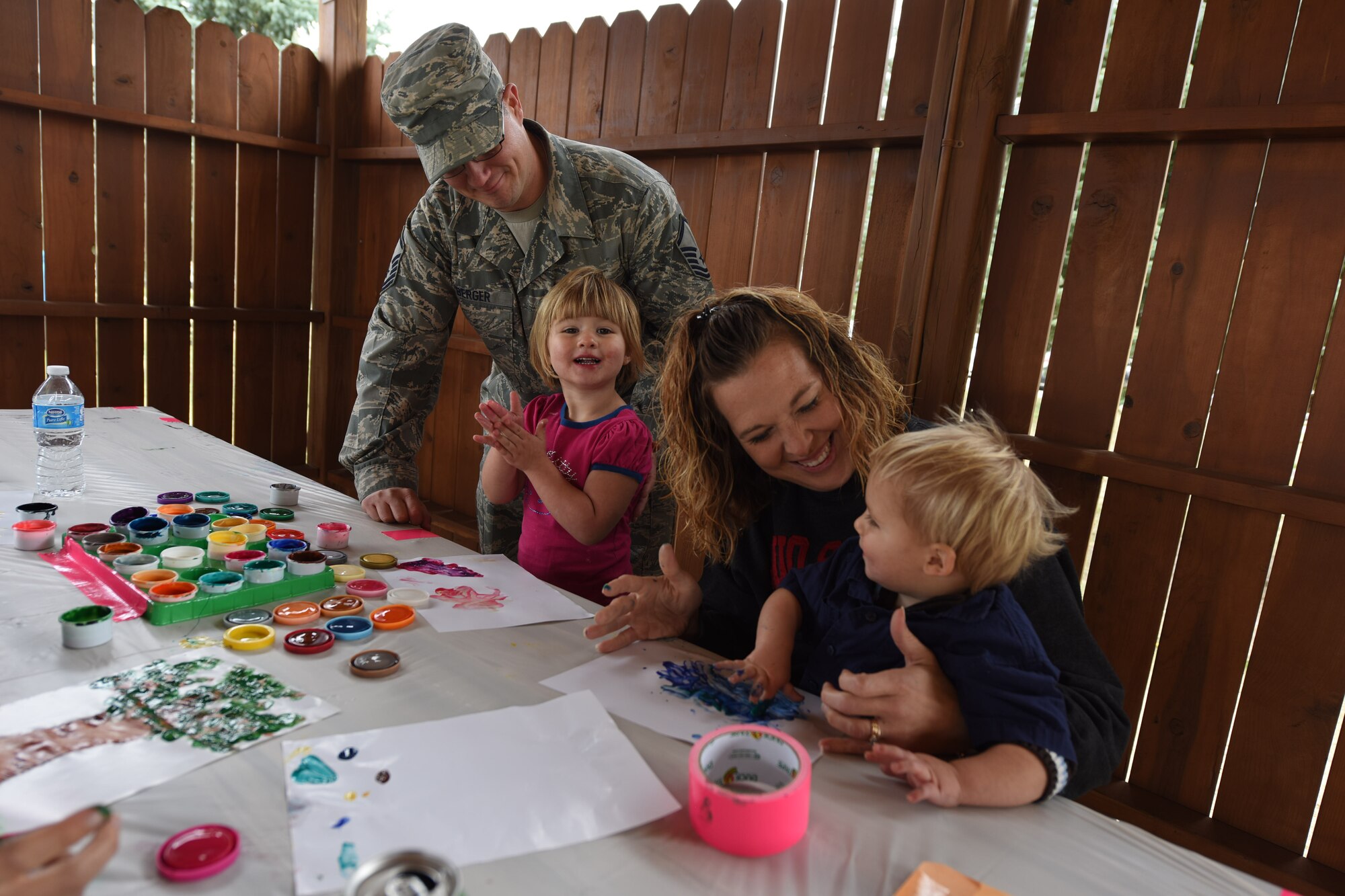 Families from the 341st Maintenance Group complete finger paintings during a picnic at Sun Plaza Park Sept. 3 at Malmstrom Air Force Base, Mont. The Berger family was one of many that participated in making finger paintings for elderly long-term care facilities in the local Great Falls community. (U.S. Air Force photo/Airman 1st Class Collin Schmidt)