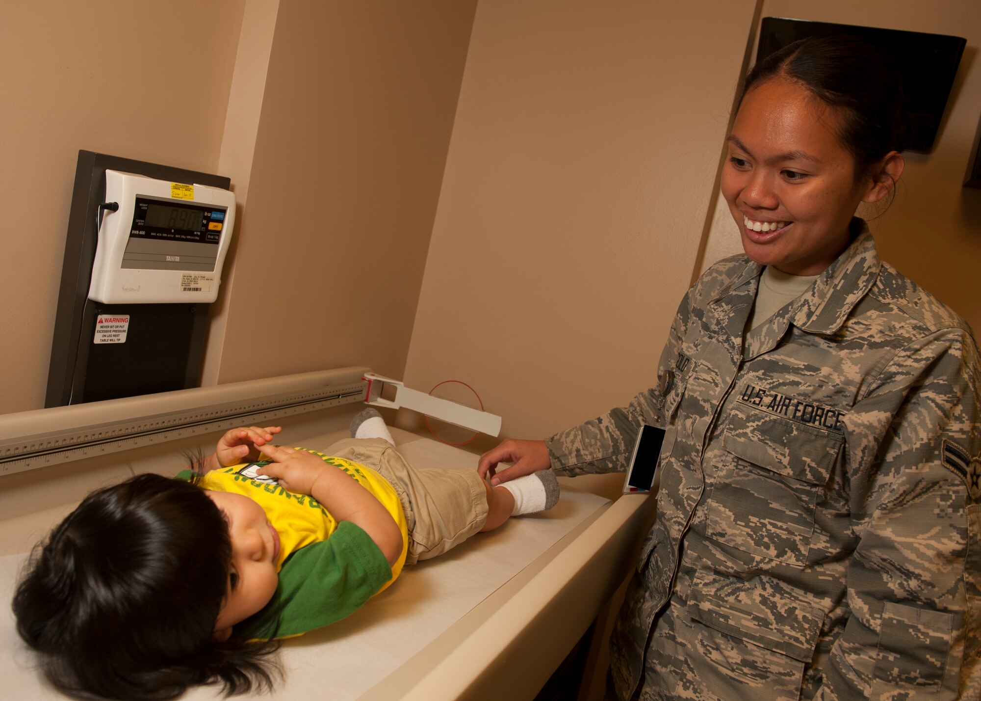 Airman 1st Class Riocornell Golo, a 19th Medical Operations Squadron medical technician, weighs a patient Aug. 12, 2015, at Little Rock Air Force Base, Ark. Golo was awarded the Chief’s Group Scholarship along with another worthy Airman, earning her $300 to assist in reaching her educational goals. (U.S. Air Force photo by Senior Airman Scott Poe)