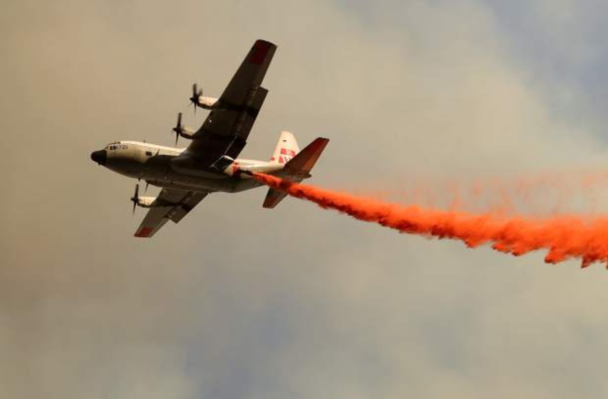 HC-130H aircraft releasing fire retardant over fire.


2401_LowellFire_T118