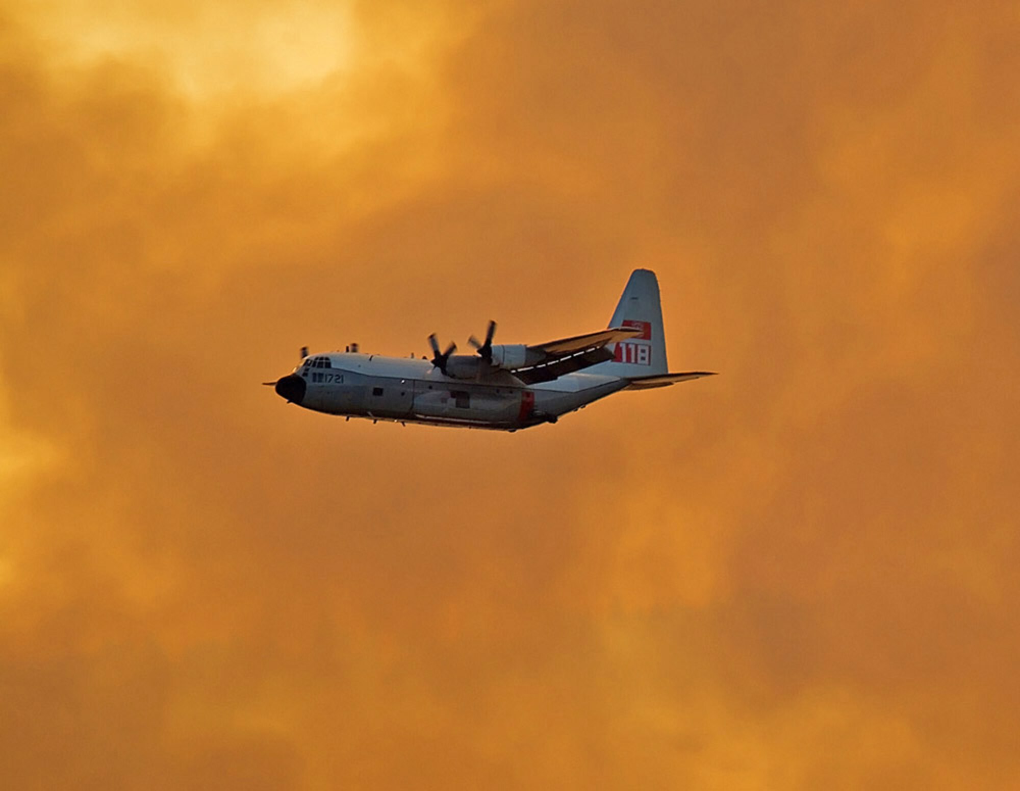 HC-130H aircraft releasing fire retardant over fire.


2401_LowellFire_T118