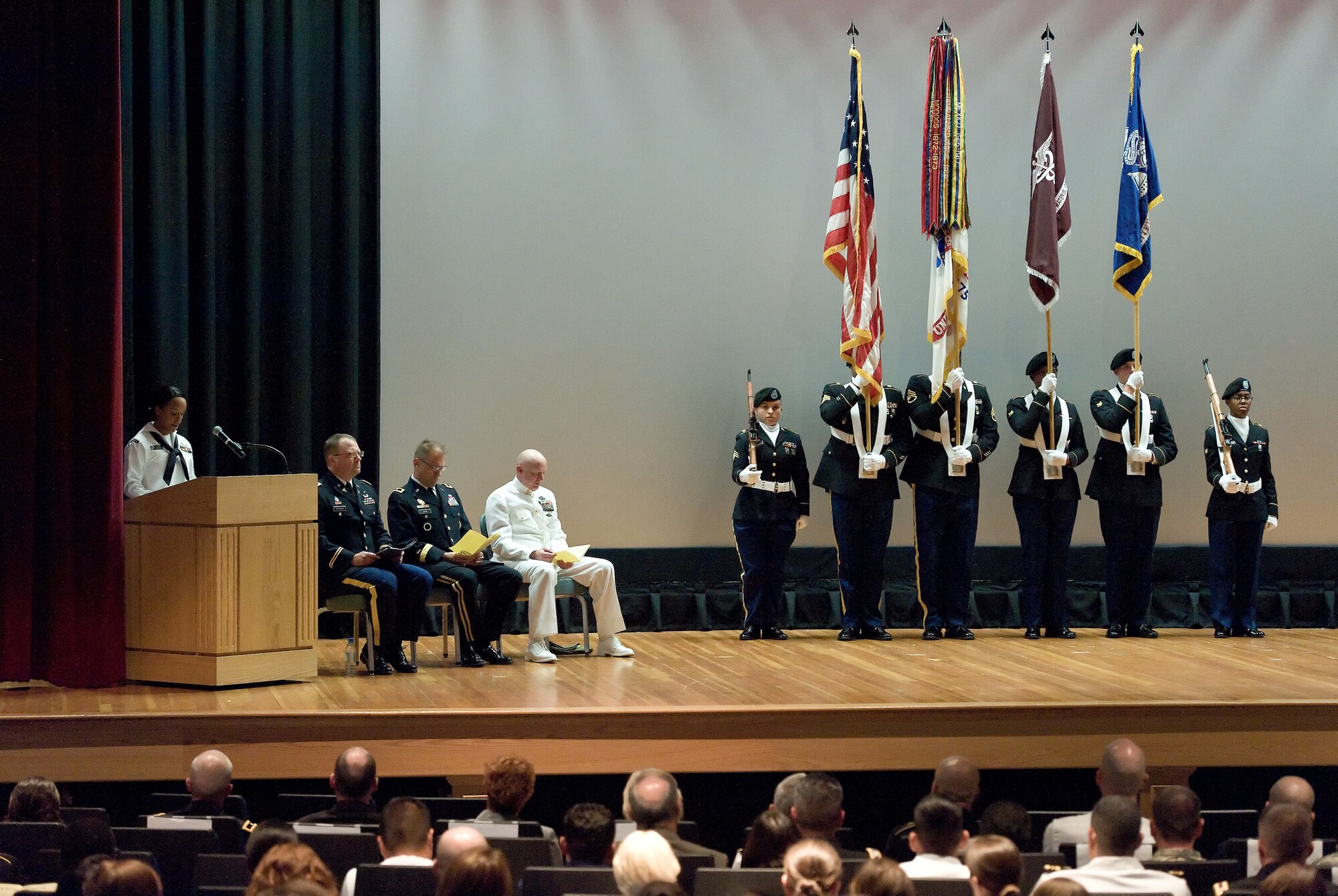 A U.S. Army Color Guard presents the colors prior to casing of the Armed Forces Medical Examiner colors Aug. 31, 2015, at the Base Theater on Dover Air Force Base, Del. Over the years, AFMES transitioned from the Armed Forces Institute of Pathology to the U.S. Army Medical Research and Material Command in the fall of 2011 with its move to Dover AFB and AFMES was formally transferred from MRMC to the Defense Health Agency in the flag-casing ceremony. (U.S. Air Force photo/Roland Balik)