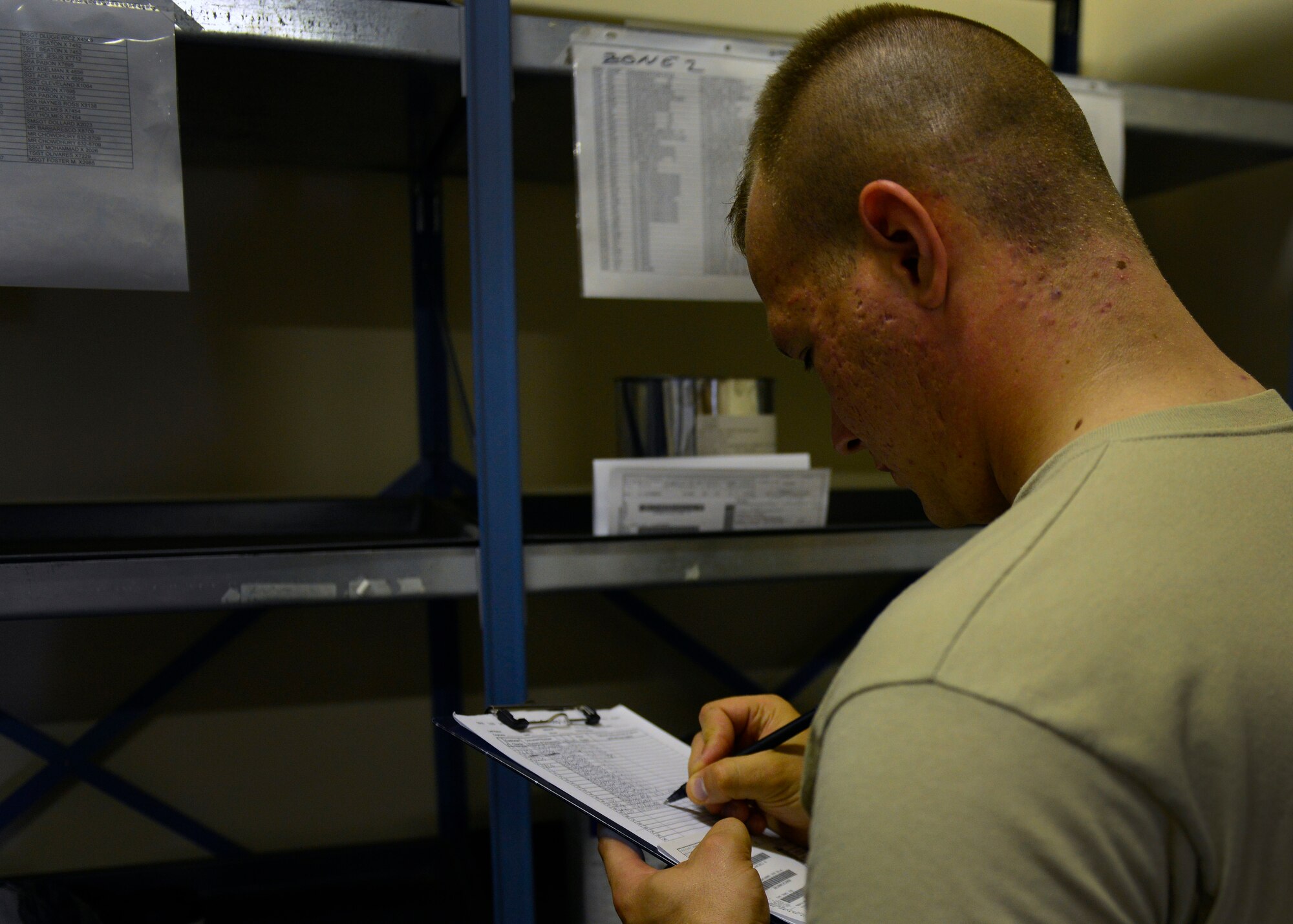 U.S. Air Force Senior Airman Anthony Wilson, 31st Logistics Readiness Squadron Vehicle Operations journeyman, checks the part numbers of items he is picking up, Sept. 2, 2015, at Aviano Air Base, Italy. Corrosive and flammable materials are stored in the 31st LRS Hazardous Material Supply warehouses until they are picked up. (U.S. Air Force photo by Airman 1st Class Cary Smith/Released)