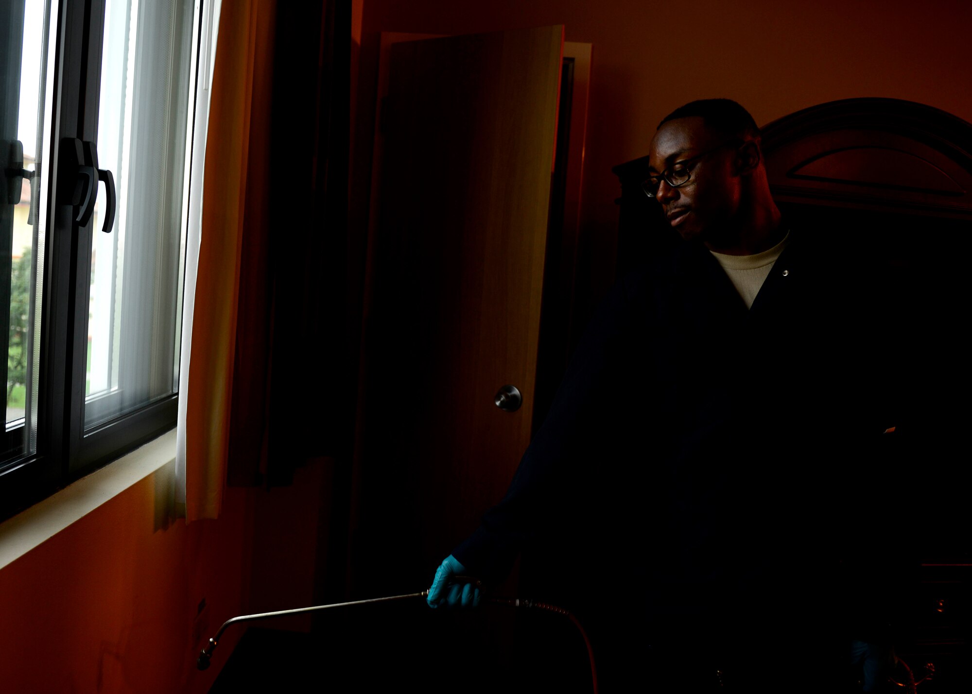 U.S. Air Force Staff Sgt. Aaron Pass, 31st Civil Engineer Squadron Pest Management NCO in charge, sprays pesticides, Sept. 2, 2015, at the Mountain View Lodge on Aviano Air Base, Italy. The pest management flight aims to prevent vermin and vegetation from adversely affecting Team Aviano. (U.S. Air Force photo by Senior Airman Areca T. Bell/Released)