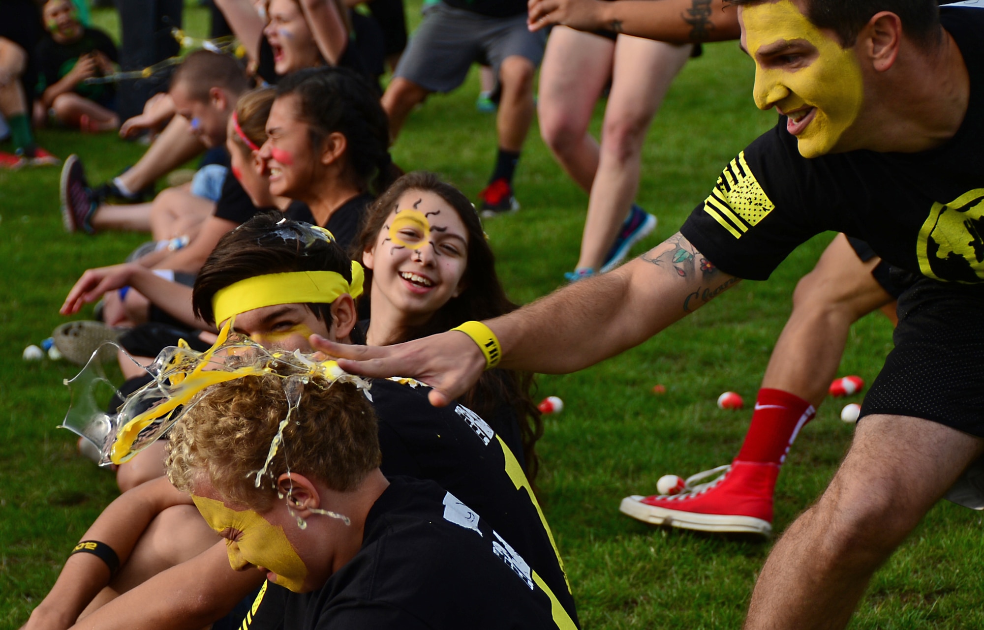 An egg is splatted over a student’s head by a team leader during a field game at Royal Air Force Lakenheath, England, Aug. 3, 2015. Teams made up of 12 team leaders and 260 middle and high school students compete in physically challenging games, known as “The RACE,” to help build new relationships and encourage interaction between the students. (U.S. Air Force photo by Senior Airman Erin O’Shea/Released)