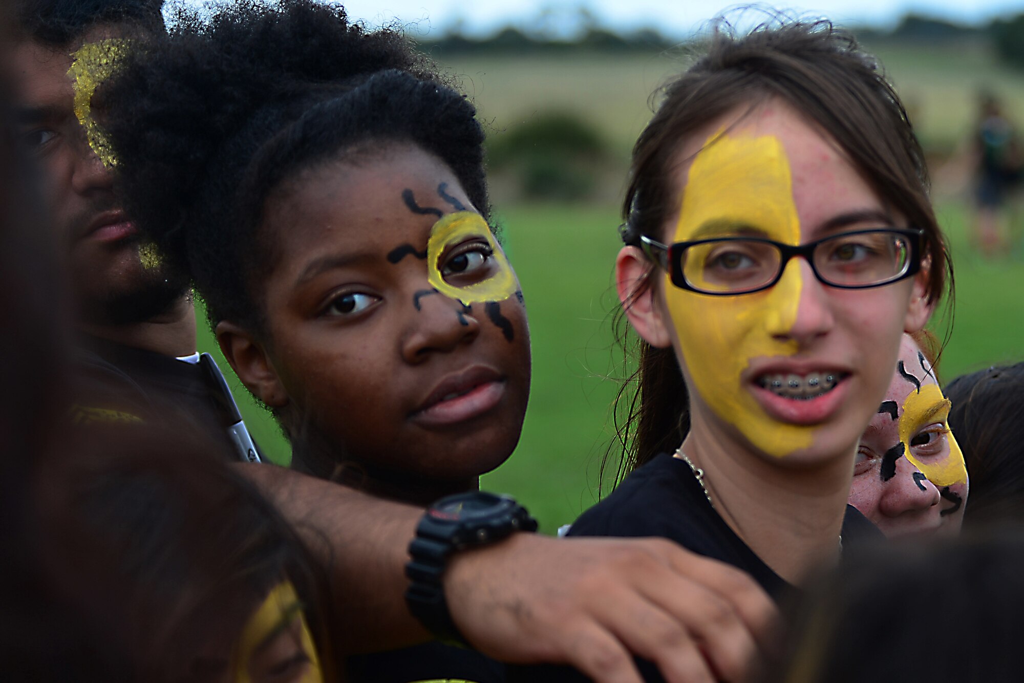 Middle and high school students prepare for a group cheer before a competitive field game at Royal Air Force Lakenheath, England, Aug. 3, 2015. The chapel sponsored event, “The RACE,” was designed to contribute to family readiness by helping students interact with each other and help socially prepare them for the upcoming school year. (U.S. Air Force photo by Senior Airman Erin O’Shea/Released)  
