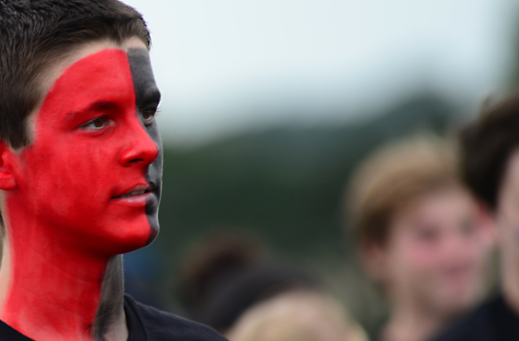 A student taking part in a competitive field game, known as “The RACE,” listens to a brief prior to the event at Royal Air Force Lakenheath, England, Aug. 3, 2015. The event involves physically challenging games that are designed to help students interact and bond in a social environment. (U.S. Air Force photo by Senior Airman Erin O’Shea/Released)