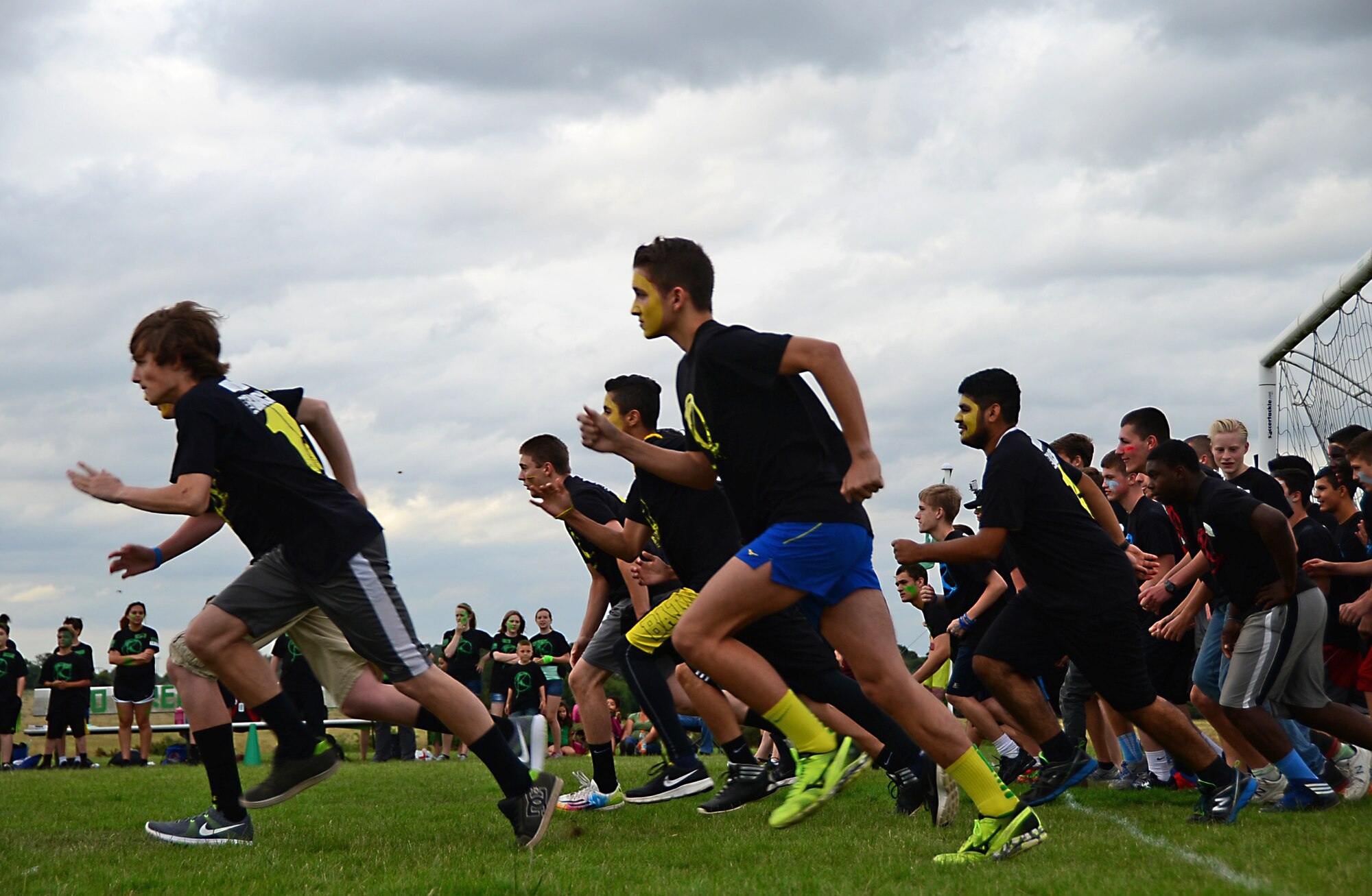 Middle and high school students run during a competitive field game at Royal Air Force Lakenheath, England, Aug. 3, 2015. The chapel sponsored event, “The RACE,” is designed to contribute to family readiness by helping students interact with each other, and help socially prepare them for the upcoming school year. (U.S. Air Force photo by Senior Airman Erin O’Shea/Released)  