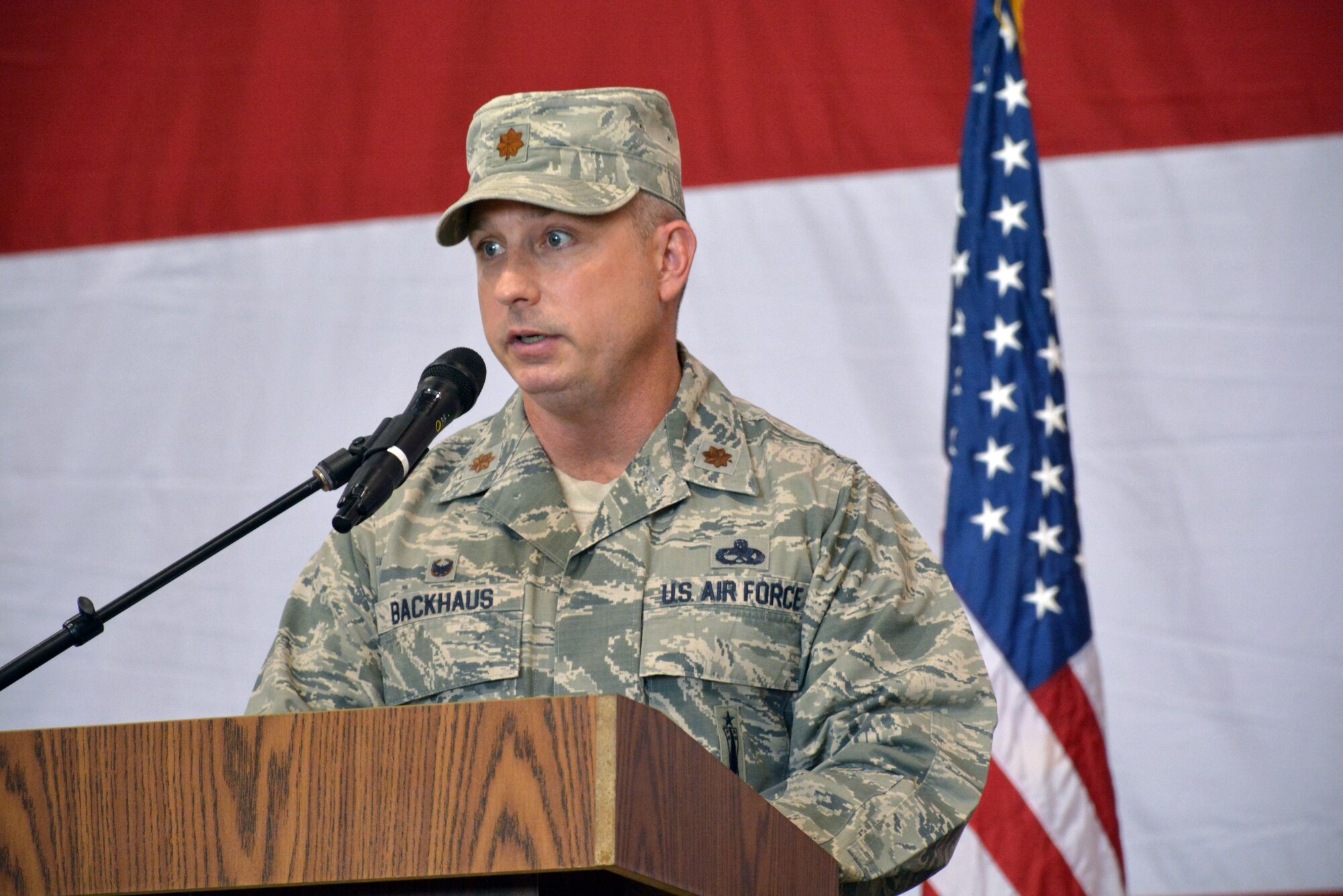 Maj. Christian Backhaus addresses the crowd for the first time after assuming command of the 552nd Aircraft Maintenance Squadron in a ceremony Monday in Bldg. 230, Dock 2. Major Backhaus replaces Lt. Col. Ronald Llantada, who recently took over as deputy commander for the 461st Maintenance Group at Robins Air Force Base, Ga. Major Backhaus previously served as commander of the 380th Expeditionary Maintenance Squadron at Al Dhafra Air Base, United Arab Emirates. Col. Andre Kennedy, 552nd Maintenance Group commander, presided over the ceremony attended by a host of family, friends and co-workers. (Air Force photo by Darren D. Heusel/Released)