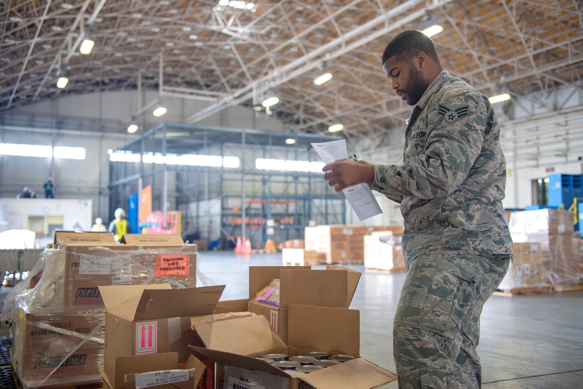 Senior Airman Johari Foshee, 374th Logistics Readiness Squadron receiving specialist, reviews a shipment order at Yokota Air Base, Japan, Sept. 2, 2015. Airmen with the 374 LRS traffic management office inspect shipments that arrive at Yokota to ensure that the load is free of any damage or defects. (U.S. Air Force photo by Airman 1st Class Delano Scott/Released)