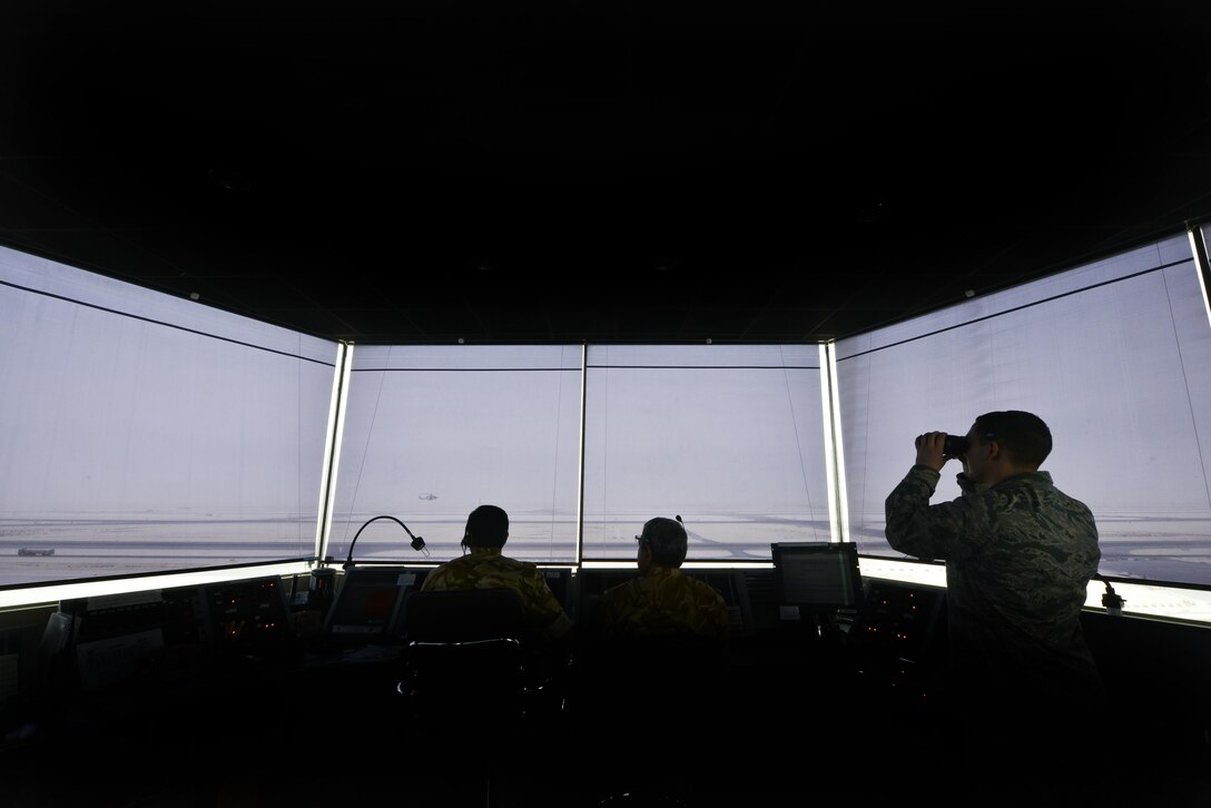 Senior Airman Nicholas Randolph, 379th Expeditionary Operations Support Squadron air traffic controller, surveys the airfield alongside Qatari military air traffic controllers to establish a safe environment for aircraft to take off and land September 2, 2015 at Al Udeid Air Base, Qatar. Airmen of the 379th EOSS ATC work closely with Qatari military ATC conducting airfield operations to support coalition forces deployed here in support of Operation Inherent Resolve and Operation Freedom’s Sentinel. (U.S. Air Force photo/Staff Sgt. Alexandre Montes)