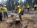 Oregon State Command Sgt. Maj. Shane Lake, center, receives instruction from Oregon Army National Guard Soldiers as he learns how to perform their work during wildfire cleanup operations in support of firefighting efforts at the Grizzly Bear Complex near Elgin, Oregon, Sept. 2, 2105. The Oregon National Guard was activated in August by Oregon Gov. Kate Brown and deployed to fire camps throughout the state to assist firefighters. 