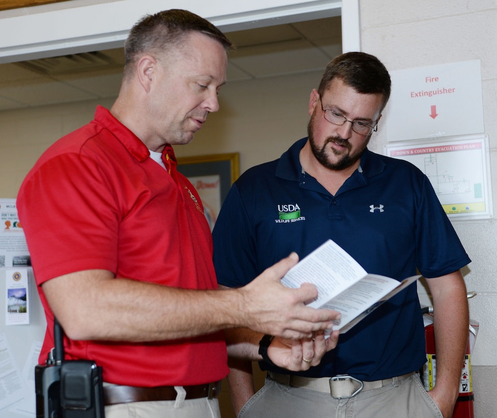 Steven Dancer, (left) emergency manager, Marine Corps Logistics Base Albany, explains to Scott Dismuke, wildlife specialist, MCLB Albany, the purpose of National Preparedness Month while manning a display booth at the Town and Country Restaurant, Sept. 1.