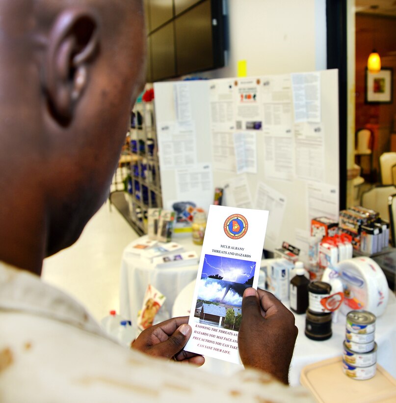 Sgt. Xzavier Thomas, Marine Corps Community Services, peruses an emergency preparedness flyer at a booth aboard Marine Corps Logistics Base Albany, recently. National Preparedness Month is underway and several static display booths will be set up at various locations including buildings 1221, 2200, 3500 and 3700. Information including how to prepare for severe weather and how to build an emergency kit as well as the installation mass notification system will be displayed at the booths.