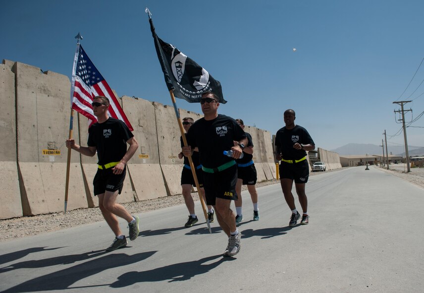 U.S. Soldiers assigned to the Resolute Support Sustainment Brigade participate in the prisoners of war, missing in action run at Bagram Airfield, Afghanistan, Sept. 3, 2015. For 24 straight hours, BAF Service members kept the POW/MIA flag in constant motion in honor of American prisoners of war and those missing in action. (U.S. Air Force photo by Tech. Sgt. Joseph Swafford/Released)