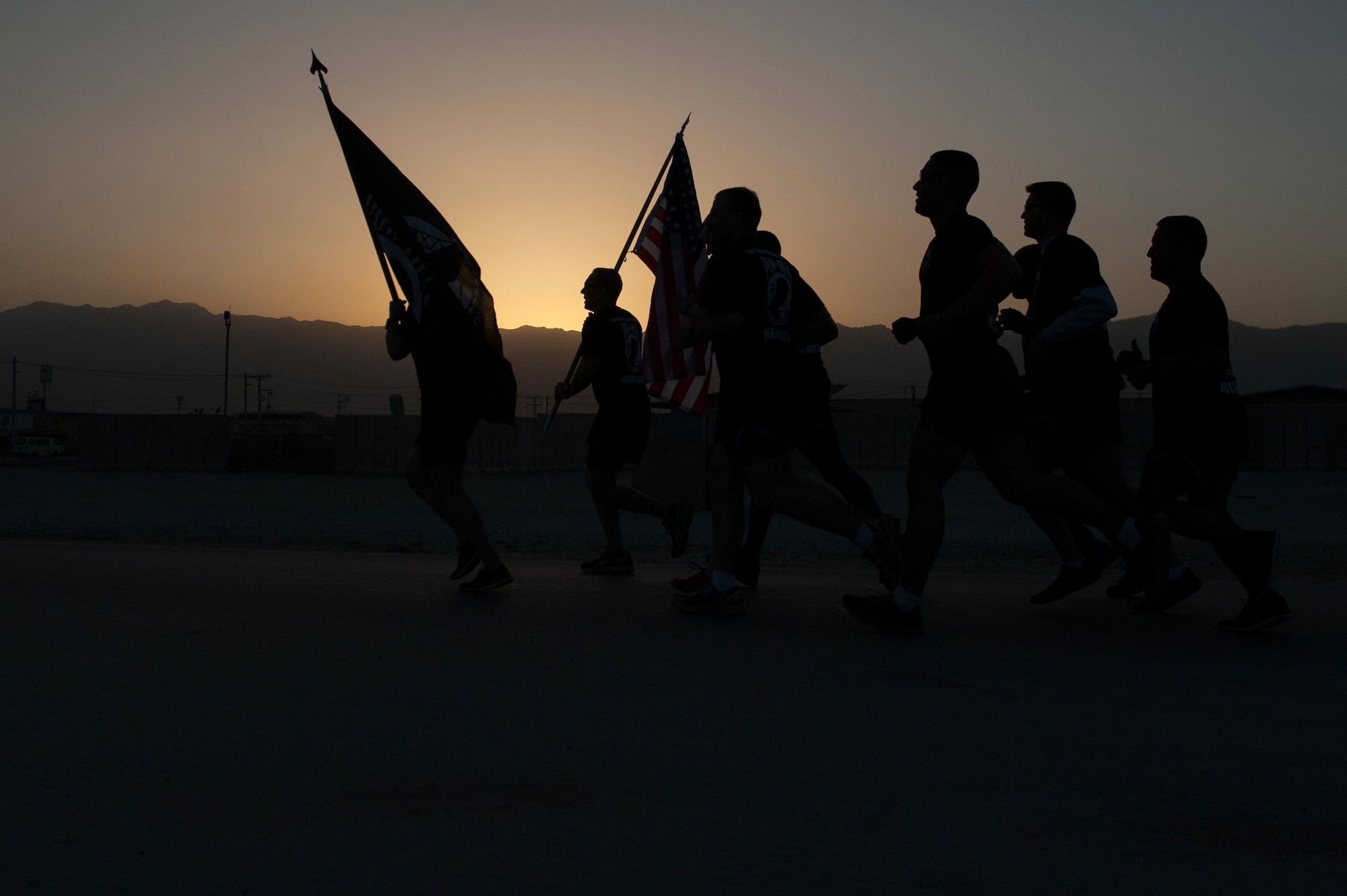 U.S. Airmen assigned to the 455th Air Expeditionary Wing participate in the prisoners of war, missing in action run at Bagram Airfield, Afghanistan, Sept. 3, 2015. For 24 straight hours, BAF Service members kept the POW/MIA flag in constant motion in honor of American prisoners of war and those missing in action. (U.S. Air Force photo by Tech. Sgt. Joseph Swafford/Released)