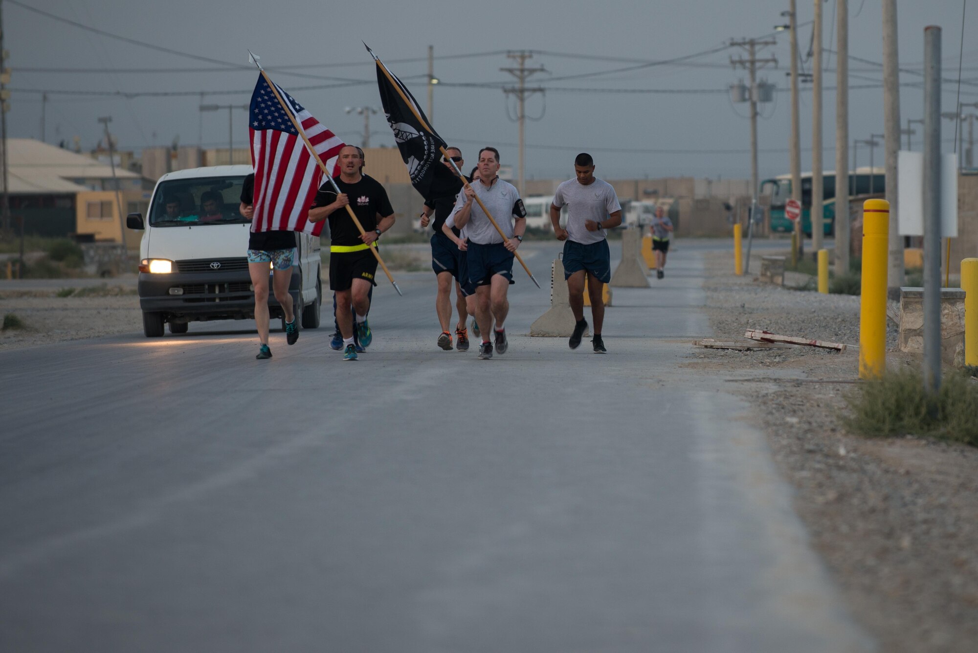 U.S. Service members participate in the prisoners of war, missing in action run at Bagram Airfield, Afghanistan, Sept. 4, 2015. For 24 straight hours, BAF Service members kept the POW/MIA flag in constant motion in honor of American prisoners of war and those missing in action. (U.S. Air Force photo by Tech. Sgt. Joseph Swafford/Released)