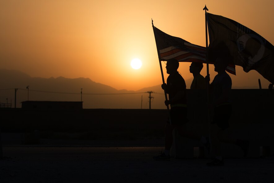 U.S. Service members participate in the prisoners of war, missing in action run at Bagram Airfield, Afghanistan, Sept. 4, 2015. For 24 straight hours, BAF Service members kept the POW/MIA flag in constant motion in honor of American prisoners of war and those missing in action. (U.S. Air Force photo by Tech. Sgt. Joseph Swafford/Released)