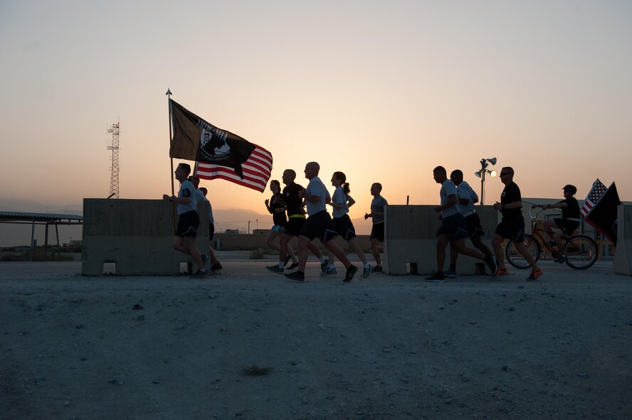 U.S. Service members participate in the prisoners of war, missing in action run at Bagram Airfield, Afghanistan, Sept. 4, 2015. For 24 straight hours, BAF Service members kept the POW/MIA flag in constant motion in honor of American prisoners of war and those missing in action. (U.S. Air Force photo by Tech. Sgt. Joseph Swafford/Released)