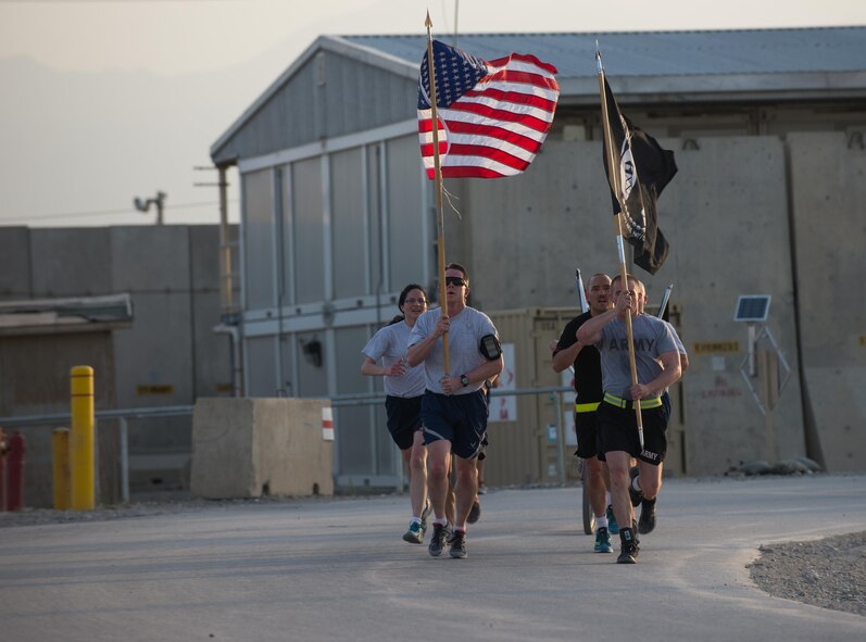 U.S. Service members participate in the prisoners of war, missing in action run at Bagram Airfield, Afghanistan, Sept. 4, 2015. For 24 straight hours, BAF Service members kept the POW/MIA flag in constant motion in honor of American prisoners of war and those missing in action. (U.S. Air Force photo by Tech. Sgt. Joseph Swafford/Released)   