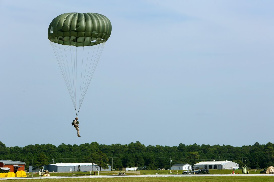 A Marine with 2nd Radio Battalion, II Marine Expeditionary Force, prepares to land at Marine Corps Auxiliary Landing Field Bogue, N.C., during parachute operations, Sept. 2, 2015. The Marines jumped from an altitude of 1,250 feet. (U.S. Marine Corps photo by Cpl. Joey Mendez/ Released)