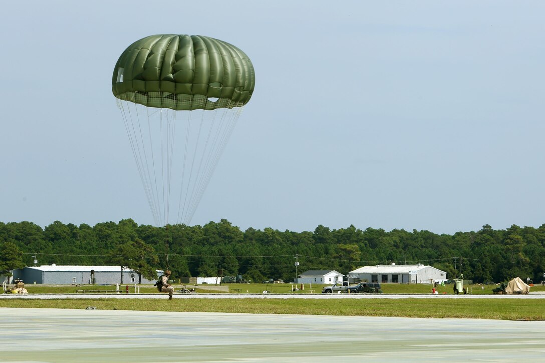 A Marine with 2nd Radio Battalion, II Marine Expeditionary Force, lands at Marine Corps Auxiliary Landing Field Bogue, N.C., during parachute operations, Sept. 2, 2015. The Marines jumped from an altitude of 1,250 feet. (U.S. Marine Corps photo by Cpl. Joey Mendez/ Released)