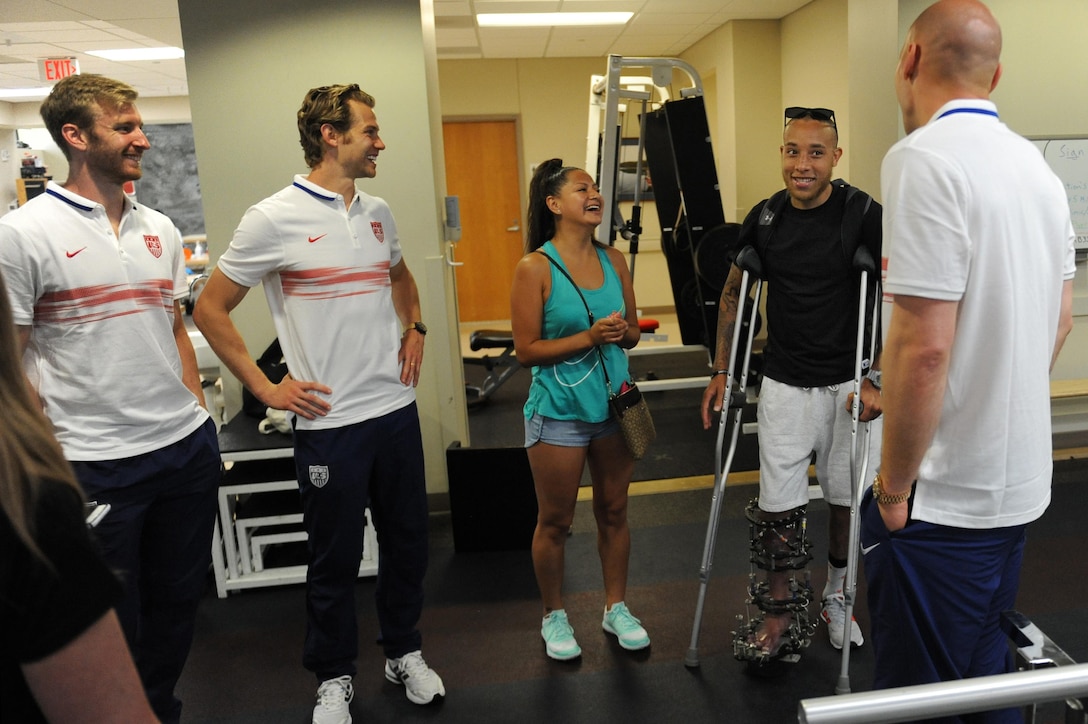 From left to right, U.S. men's national soccer team members Tim Ream, Jonathan Spector and Brad Guzan talk with Alan Thomas, a wounded warrior, and his wife, Gabriel, at Walter Reed National Medical Center in Bethesda, Md., Sept. 3, 2015. DoD photo by Marvin Lynchard