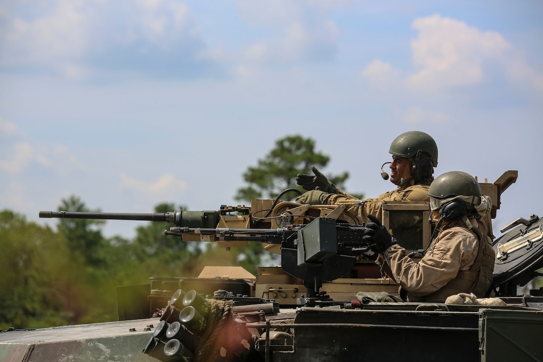 Marines with Alpha Company, 2nd Tank Battalion, provide suppressing fire for Marines with Golf Company, 2nd Battalion, 2nd Marine Regiment, during an integrated exercise at Landing Zone Dodo, Camp Lejeune, N.C., Sept. 2, 2015. The tankers provided simulated suppressive fire to support the infantry. (U.S. Marine Corps photo by Cpl. Paul S. Martinez/Released)