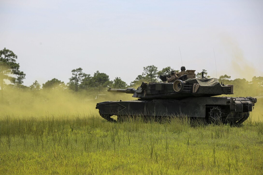 Marines with Alpha Company, 2nd Tank Battalion, roll through smoke to meet Marines with Golf Company, 2nd Battalion, 2nd Marine Regiment, during an integrated exercise at Landing Zone Dodo, Camp Lejeune, N.C., Sept. 2, 2015. The purpose of the exercise was to allow Marine infantry and tankers to work together. (U.S. Marine Corps photo by Cpl. Paul S. Martinez/Released)