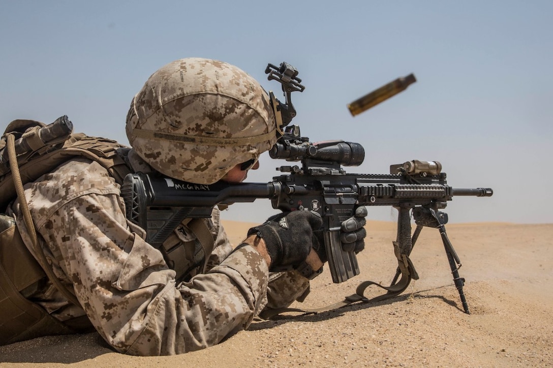 KUWAIT (Aug. 24, 2015) U.S. Marine Lance Cpl. Travis McGray engages targets during mechanized squad attack training. McGray is an automatic rifleman with Kilo Company, Battalion Landing Team 3rd Battalion, 1st Marine Regiment, 15th Marine Expeditionary Unit (MEU). The training focused on the squad’s ability to effectively utilize AAV-7 Amphibious Assault Vehicles and M1A1 Abrams tanks to close with and destroy enemy targets. Elements of the 15th MEU are ashore in Kuwait for sustainment training to maintain and enhance the skills they developed during their pre-deployment training period.  The 15th MEU is embarked with the Essex Amphibious Ready Group and deployed to maintain regional security in the U.S. 5th Fleet area of operations. (U.S. Marine Corps photo by Sgt. Emmanuel Ramos/Released)