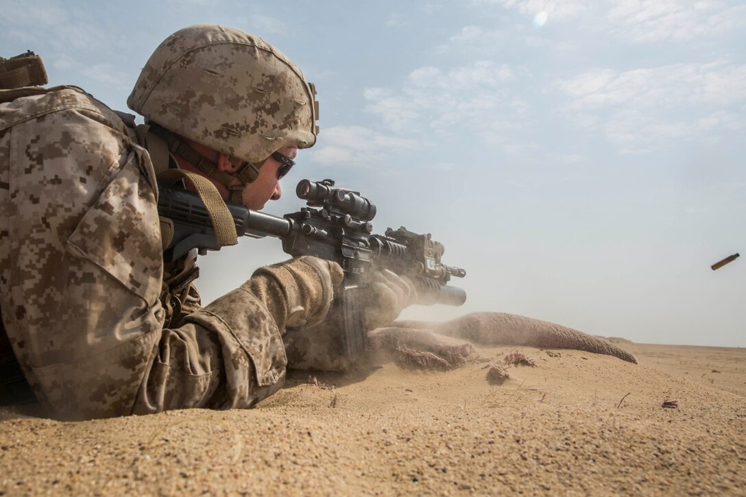 KUWAIT (Aug. 25, 2015) U.S. Marine Cpl. Willie Stevens engages targets during mechanized squad attack training. Stevens is a team leader with Kilo Company, Battalion Landing Team 3rd Battalion, 1st Marine Regiment, 15th Marine Expeditionary Unit. The training focused on the squad’s ability to work as a cohesive unit while using AAV-7 Amphibious Assault Vehicles and M1A1 Abrams tanks to effectively eliminate enemy targets. Elements of the 15th MEU are ashore in Kuwait for sustainment training to maintain and enhance the skills they developed during their pre-deployment training period. The 15th MEU is embarked with the Essex Amphibious Ready Group and deployed to maintain regional security in the U.S. 5th Fleet area of operations. (U.S. Marine Corps photo by Sgt. Emmanuel Ramos/Released)