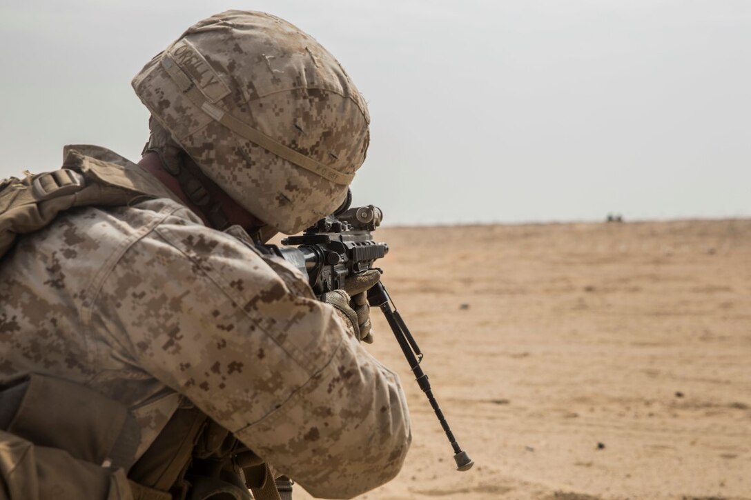 KUWAIT (Aug. 25, 2015) U.S. Marine Cpl. Edward O’Reilly engages targets during mechanized squad attack training. O’Reilly is a team leader with Kilo Company, Battalion Landing Team 3rd Battalion, 1st Marine Regiment, 15th Marine Expeditionary Unit. The training focused on the squad’s ability to work as a cohesive unit, while using AAV-7 Amphibious Assault Vehicles and M1A1 Abrams tanks, to effectively eliminate enemy targets. Elements of the 15th MEU are ashore in Kuwait for sustainment training to maintain and enhance the skills they developed during their pre-deployment training period.  The 15th MEU is embarked with the Essex Amphibious Ready Group and deployed to maintain regional security in the U.S. 5th Fleet area of operations. (U.S. Marine Corps photo by Sgt. Emmanuel Ramos/Released)
