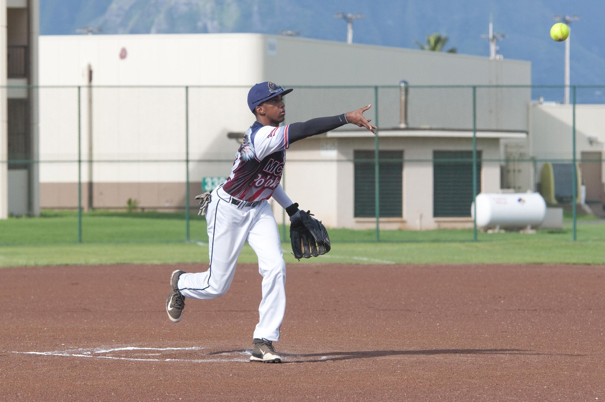 Marine Corps Base player Petty Officer 2nd Class Matt Miles, an aviation electronics technician with Special Projects Patrol Squadron 2 and San Diego native, pitches the ball during an Armed Forces Softball Tournament game at Riseley Field, Aug. 29, 2015. The Rad team beat the Marine Corps Base team, 8-4. Several of the teams were made up of service members from different branches, dependents and Department of Defense civilians. Overall, an Army team based out of Schofield Barracks in Wahiawa, Hawaii, took first place, and the Rad team took second. Recreational events such as the softball tournament help boost morale aboard Marine Corps Base Hawaii, furthering the mission, which is to provide better service for the units, individuals and families in order to enhance and sustain combat readiness for all operating forces and tenant organizations aboard the installation. (U.S. Marine Corps photo by Kristen Wong/Released) 